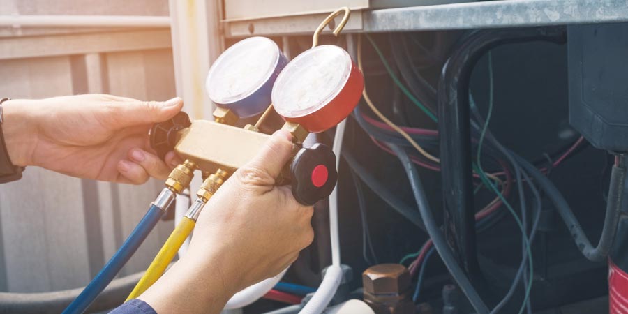 service technician checking guages