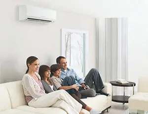 York County PA family on sofa with Mitsubishi ductless mini-split mounted above providing year round comfort
