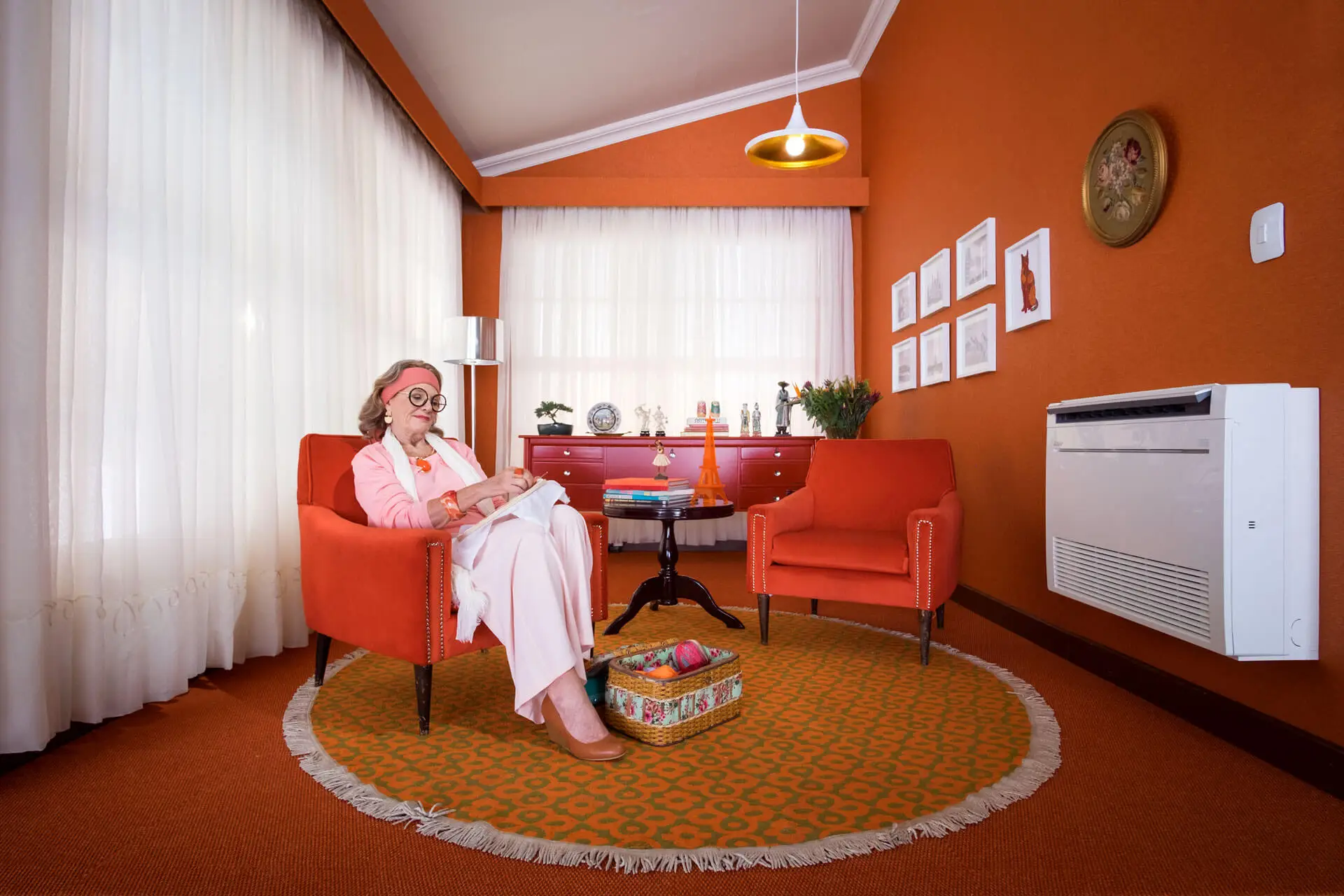 Homeowner relaxing near Mitsubishi floor mounted ductless mini-split unit in York County PA home