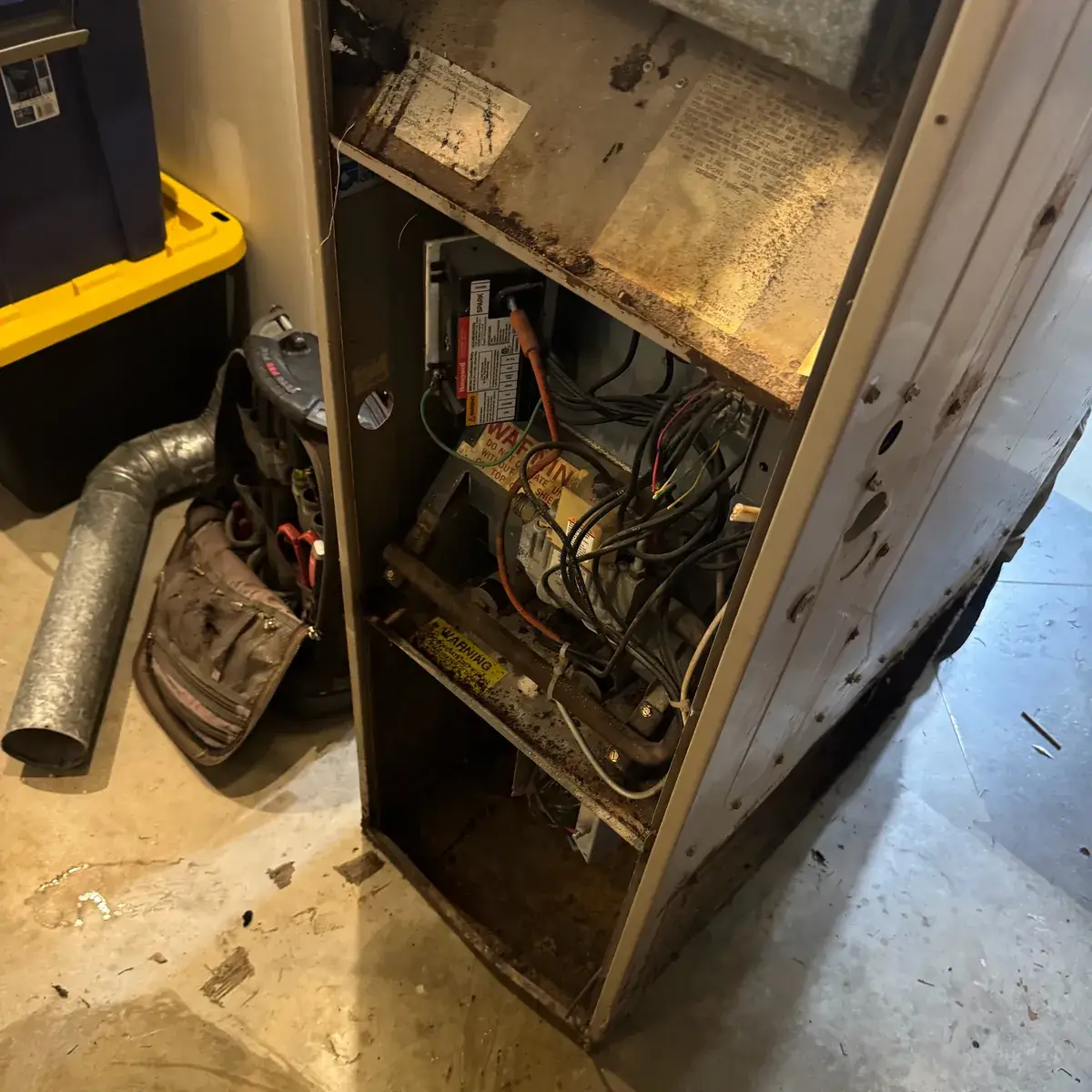 Old rusted furnace opened for inspection during a heating maintenance visit in York County, PA