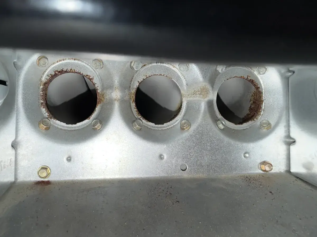Rust around the heat exchanger openings on a gas furnace found during a maintenance visit in Shrewsbury, York County, PA