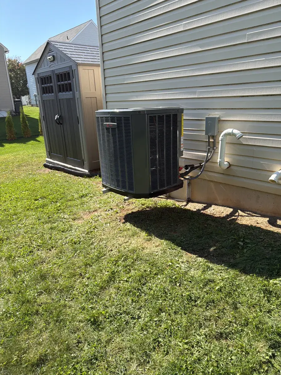 New Trane outdoor air conditioning unit installed beside a home with light siding in Red Lion, PA